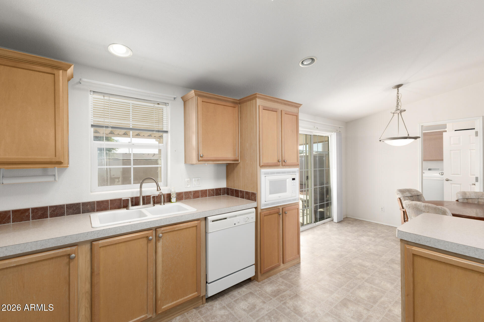 16101 North El Mirage Road, Unit 429 El Mirage, AZ 85335 - Photo 7 of 31 a kitchen with a sink stove and cabinets