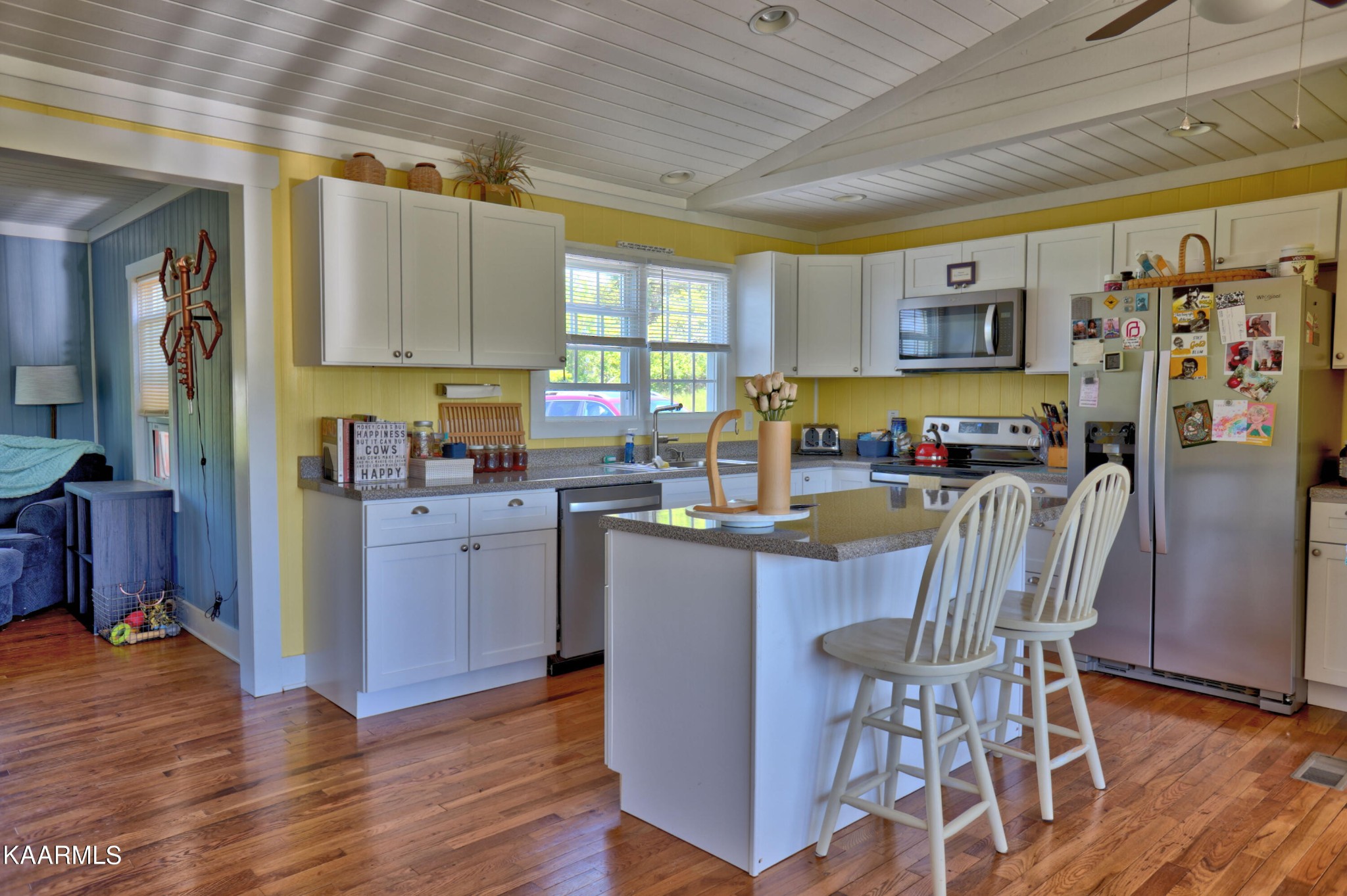 577 Wells Spring Road Dandridge, TN 37725 - Photo 11 of 28 a kitchen with stainless steel appliances a dining table chairs refrigerator and sink