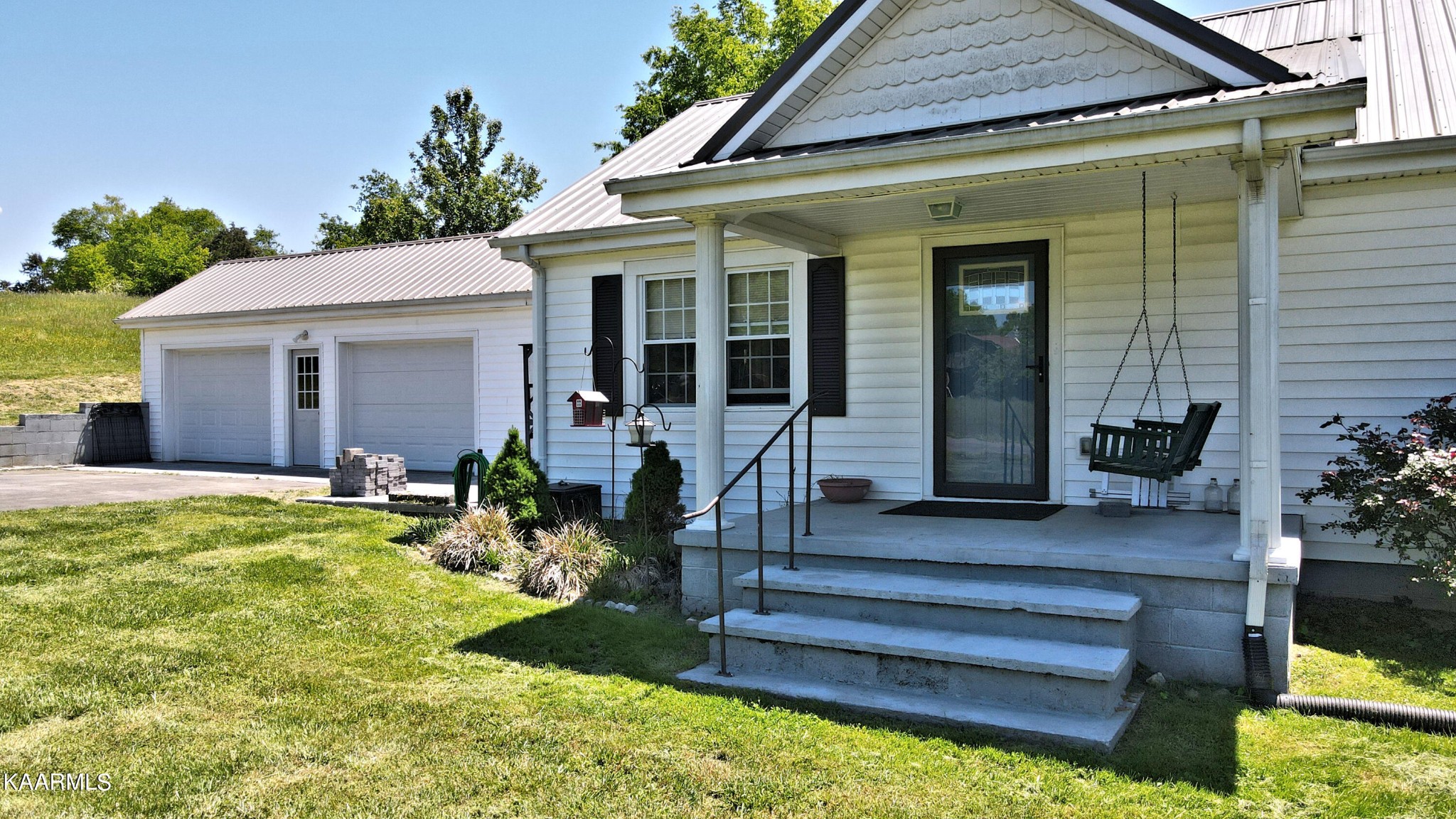 577 Wells Spring Road Dandridge, TN 37725 - Photo 3 of 28 a front view of a house with garden and patio