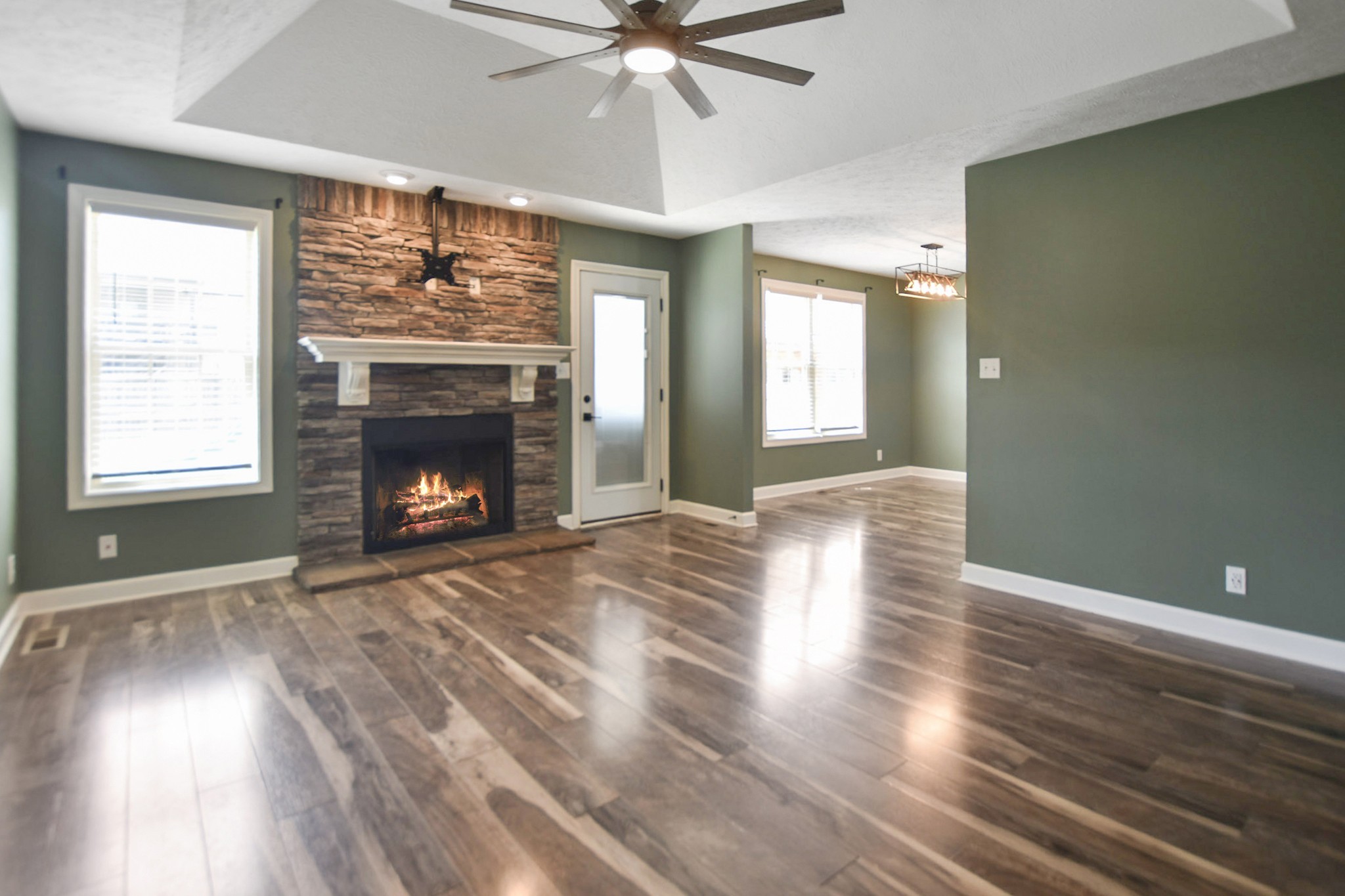 3710 Suiter Road Clarksville, TN 37040 - Photo 2 of 18 a view of an empty room with wooden floor fireplace and a window