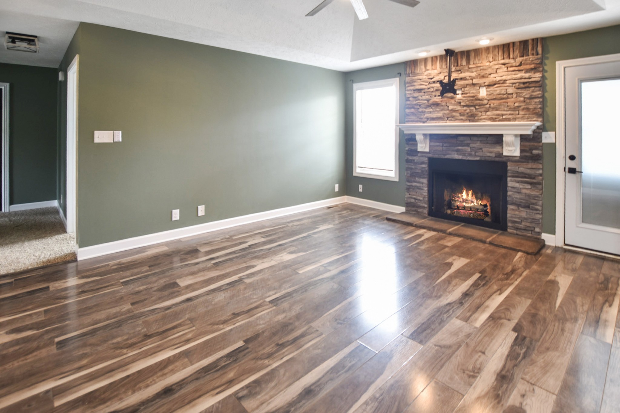 3710 Suiter Road Clarksville, TN 37040 - Photo 3 of 18 a view of empty room with wooden floor and fireplace