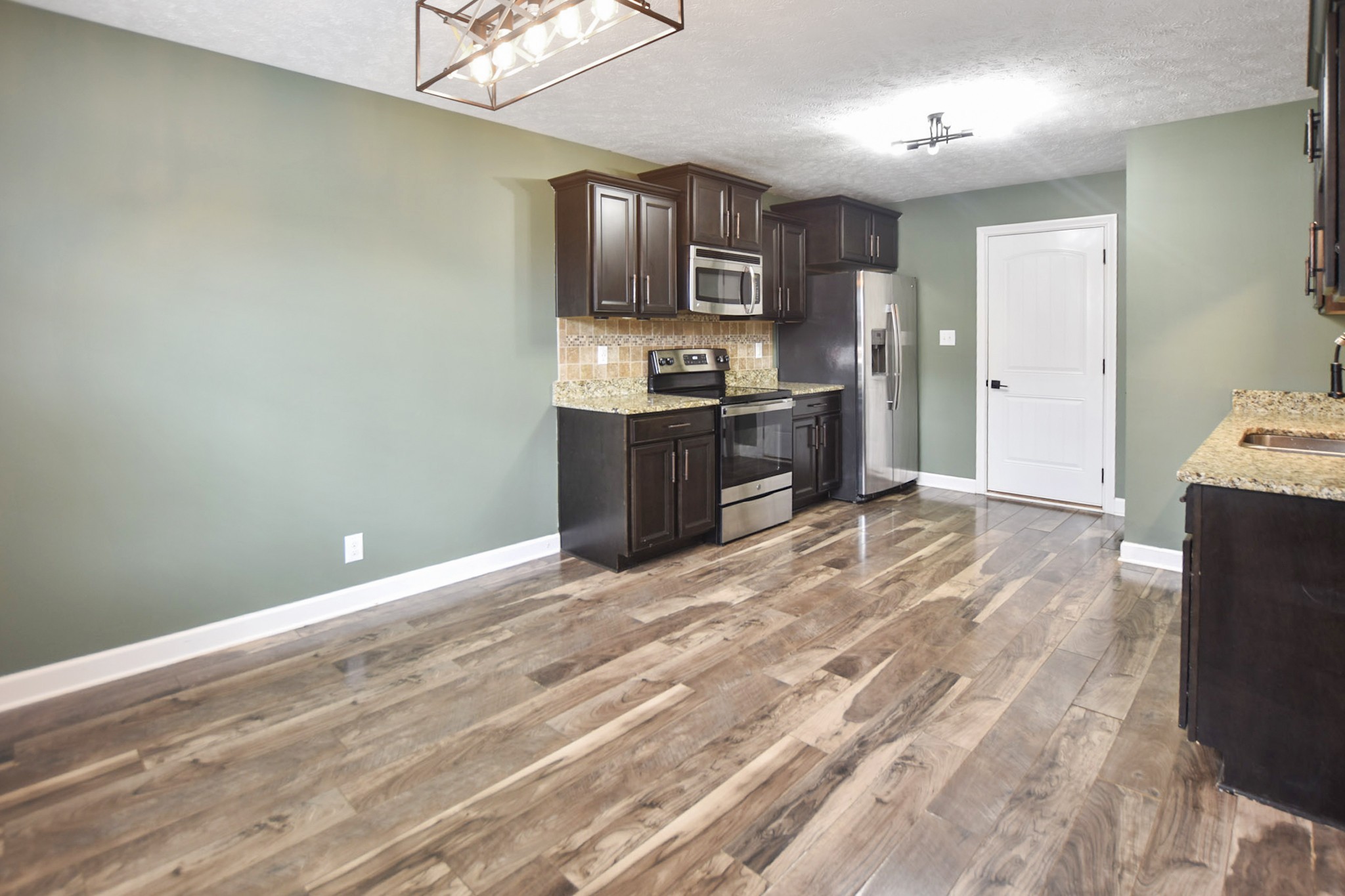 3710 Suiter Road Clarksville, TN 37040 - Photo 6 of 18 a kitchen with granite countertop a refrigerator stove top oven and sink