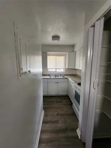 a kitchen with stainless steel appliances a refrigerator sink and cabinets