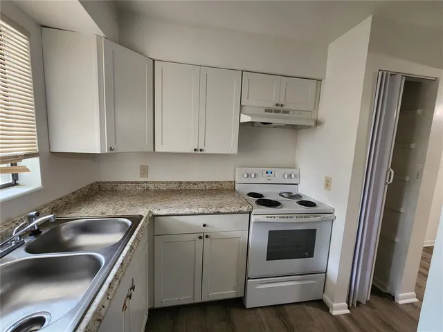 a kitchen with cabinets a sink and stainless steel appliances