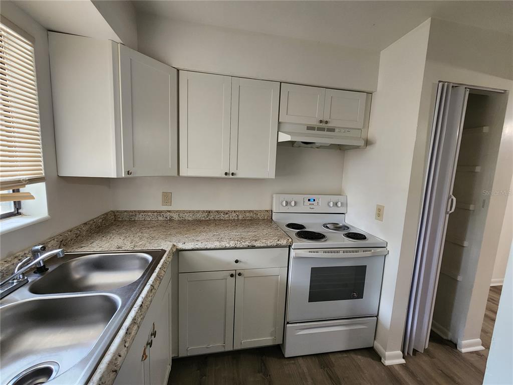 806 Southwest 64th Terrace, Unit C Gainesville, FL 32607 - Photo 12 of 28 a kitchen with cabinets a sink and stainless steel appliances