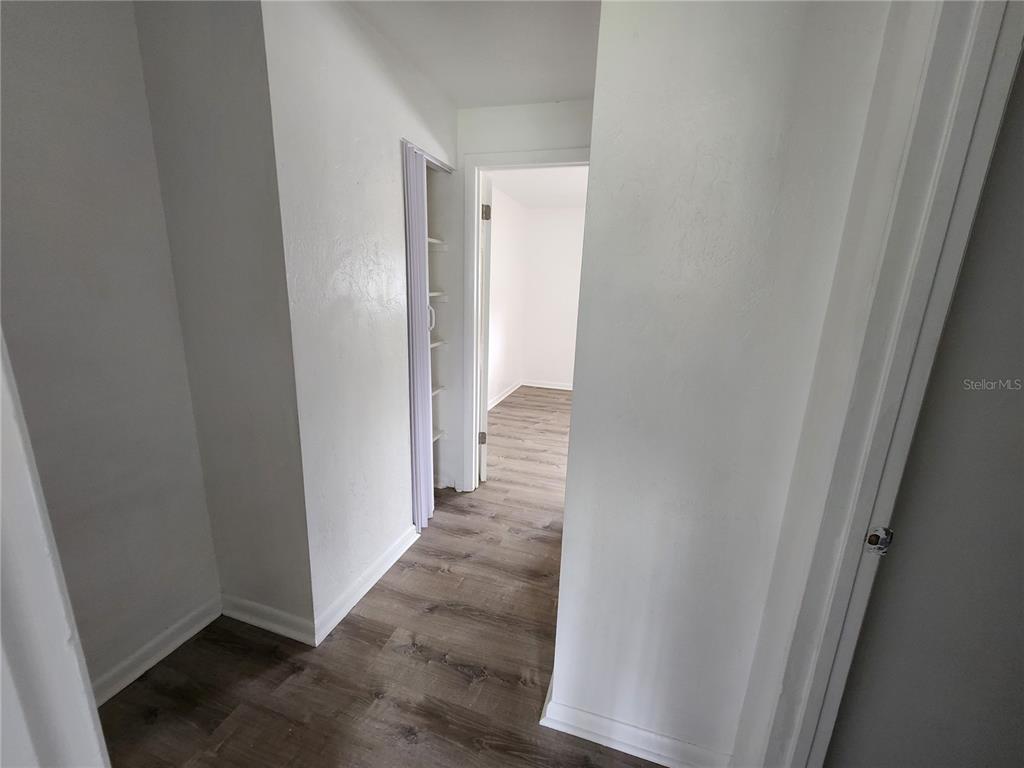 806 Southwest 64th Terrace, Unit C Gainesville, FL 32607 - Photo 16 of 28 a view of a hallway with wooden floor