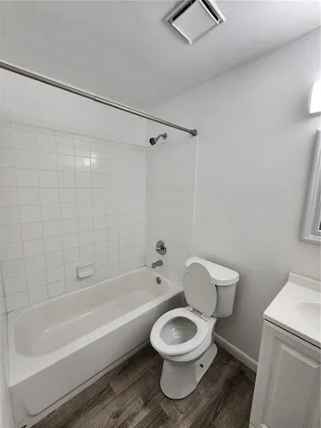 a bathroom with a toilet and a bathtub