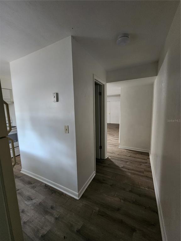 806 Southwest 64th Terrace, Unit C Gainesville, FL 32607 - Photo 2 of 28 an empty room with wooden floor and entrance