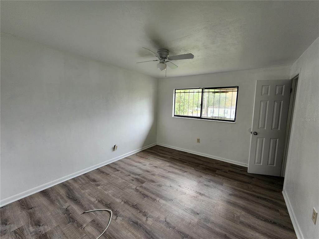 806 Southwest 64th Terrace, Unit C Gainesville, FL 32607 - Photo 21 of 28 wooden floor in an empty room with a window