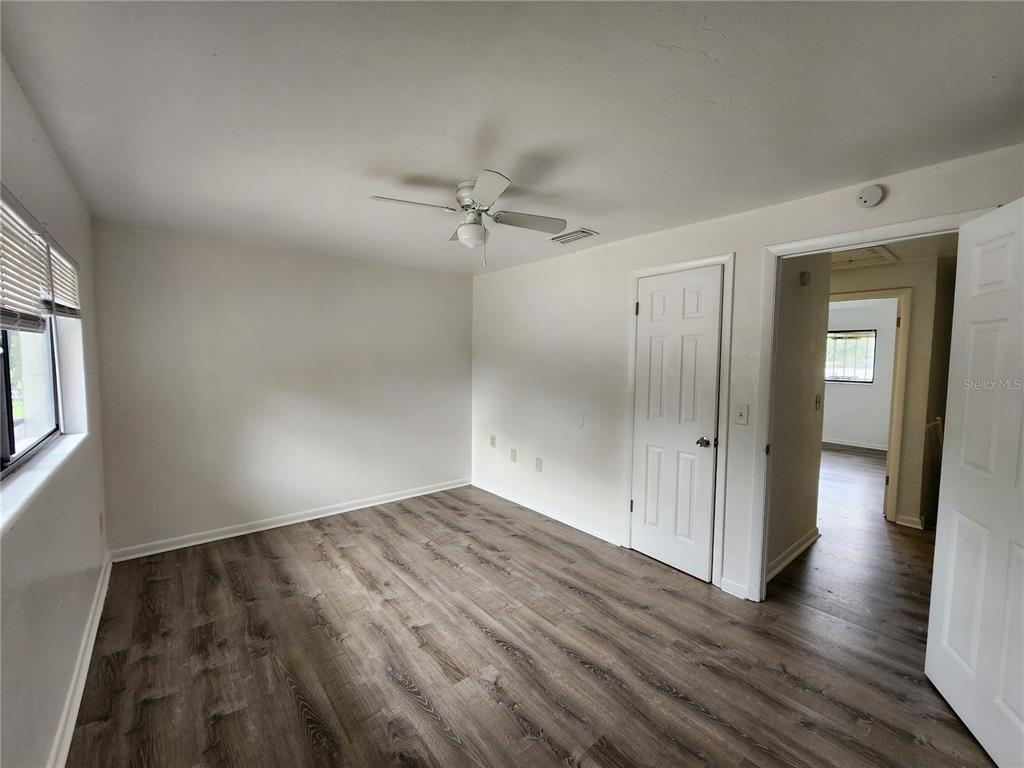 806 Southwest 64th Terrace, Unit C Gainesville, FL 32607 - Photo 24 of 28 wooden floor in an empty room with a window