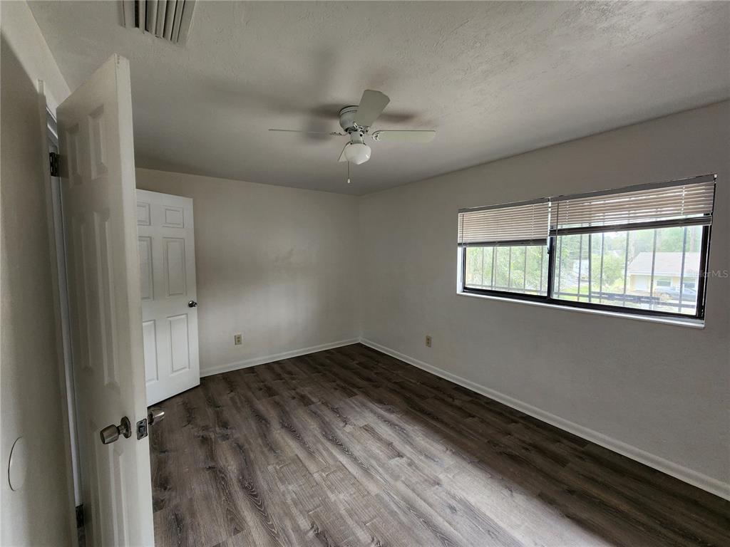 806 Southwest 64th Terrace, Unit C Gainesville, FL 32607 - Photo 26 of 28 a view of an empty room with a window