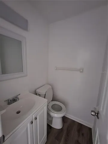 a white toilet sitting next to a bathroom sink