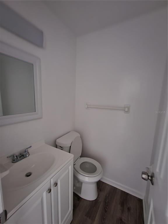 806 Southwest 64th Terrace, Unit C Gainesville, FL 32607 - Photo 4 of 28 a white toilet sitting next to a bathroom sink