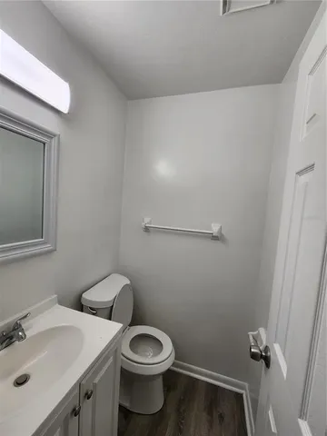 a bathroom with a sink a toilet and mirror