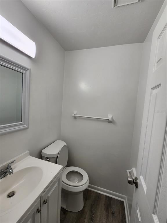 806 Southwest 64th Terrace, Unit C Gainesville, FL 32607 - Photo 6 of 28 a bathroom with a sink a toilet and mirror