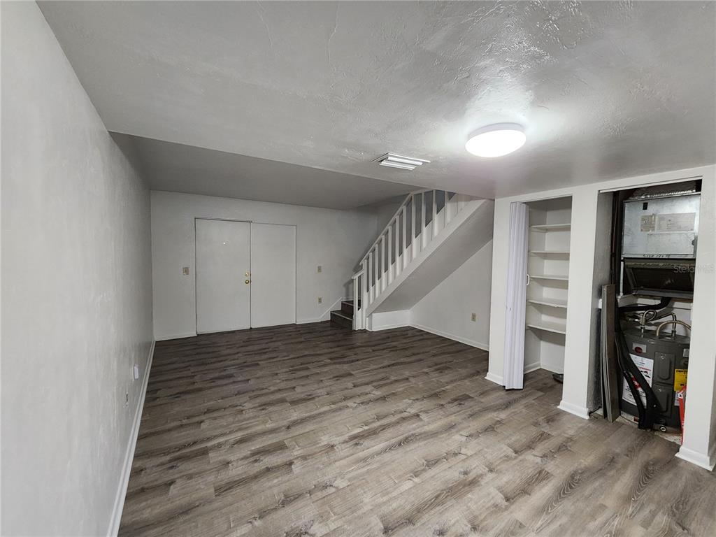 806 Southwest 64th Terrace, Unit C Gainesville, FL 32607 - Photo 8 of 28 a view of empty room with wooden floor