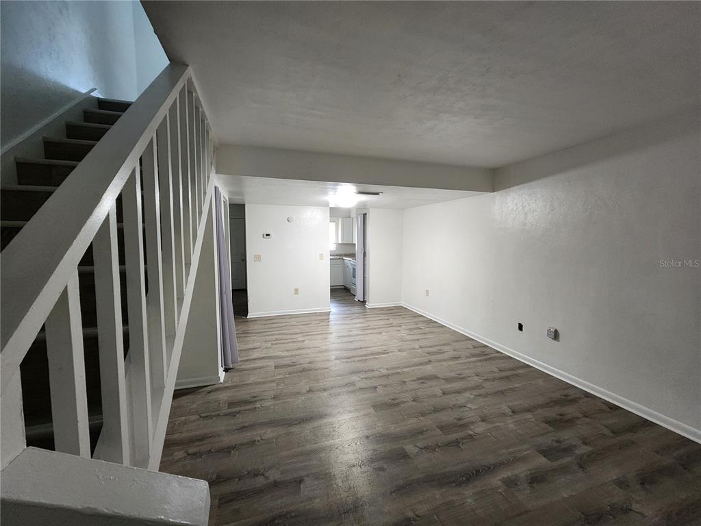 806 Southwest 64th Terrace, Unit C Gainesville, FL 32607 - Photo 10 of 28 a view of empty room with wooden floor