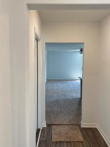 a utility room with wooden floor washer and dryer