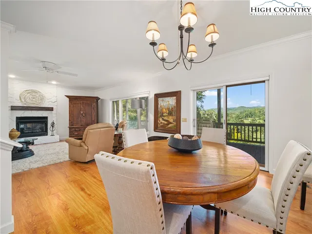 a view of a dining room with furniture wooden floor and chandelier