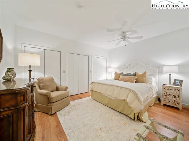 a bedroom with a bed and ceiling fan