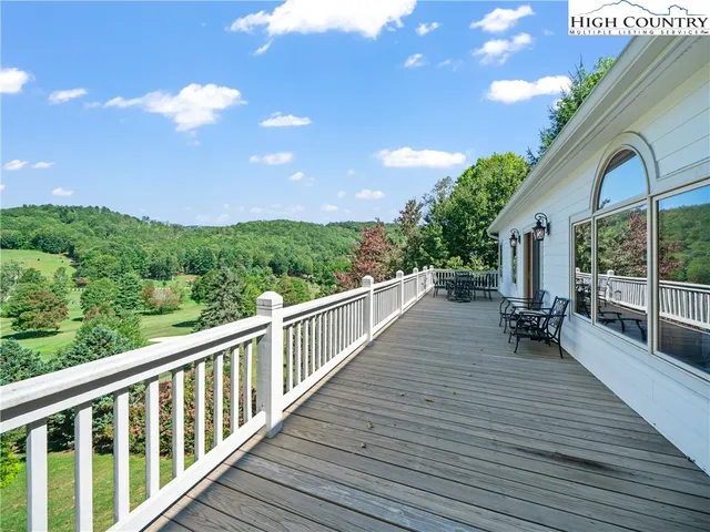 a view of a house with wooden deck