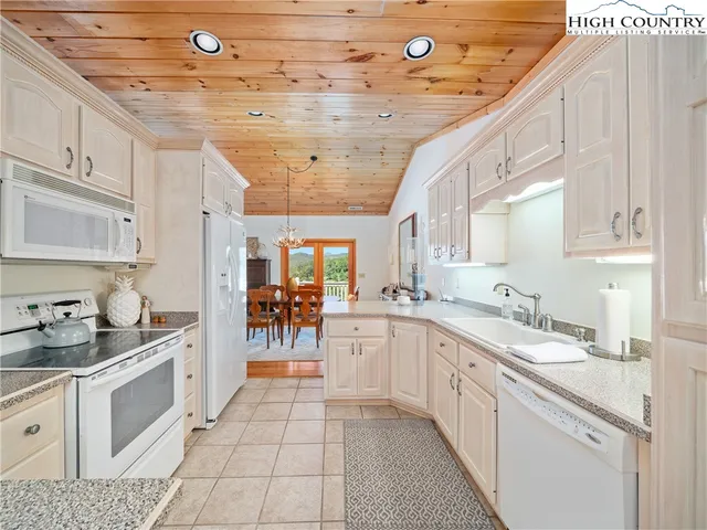 a kitchen with a sink window and cabinets