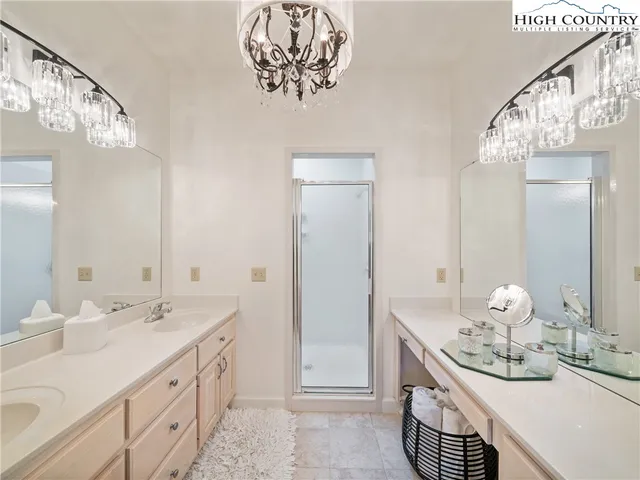 a bathroom with a sink a mirror and a clock on the wall