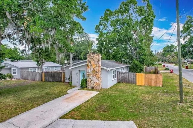 a view of a house with backyard and a small cabin