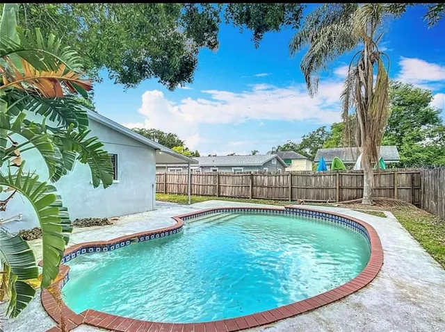 a swimming pool with outdoor seating and deck