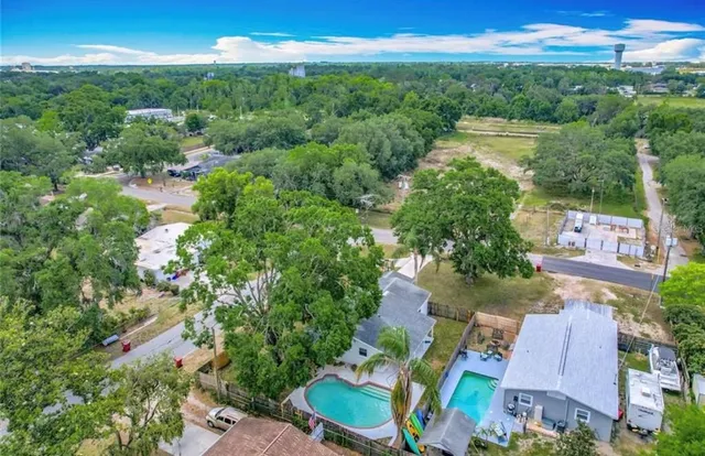 an aerial view of residential houses with outdoor space and street view