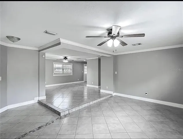 a view of a livingroom with a ceiling fan and window