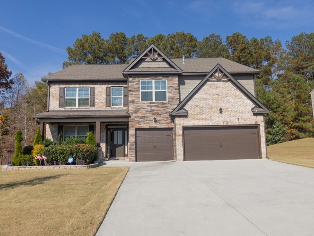 3577 Parkside View Boulevard Dacula, GA 30019 - Photo 1 of 1 a front view of a house with a yard and garage