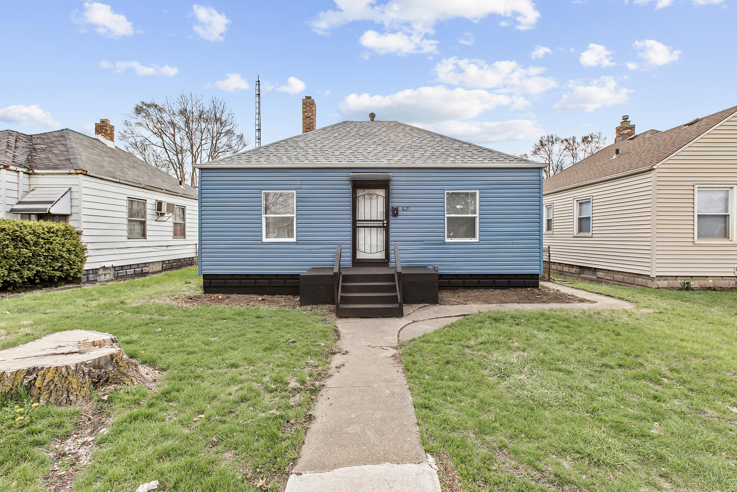 621 Burr Street Gary, IN 46406 - Photo 2 of 13 a front view of a house with garden