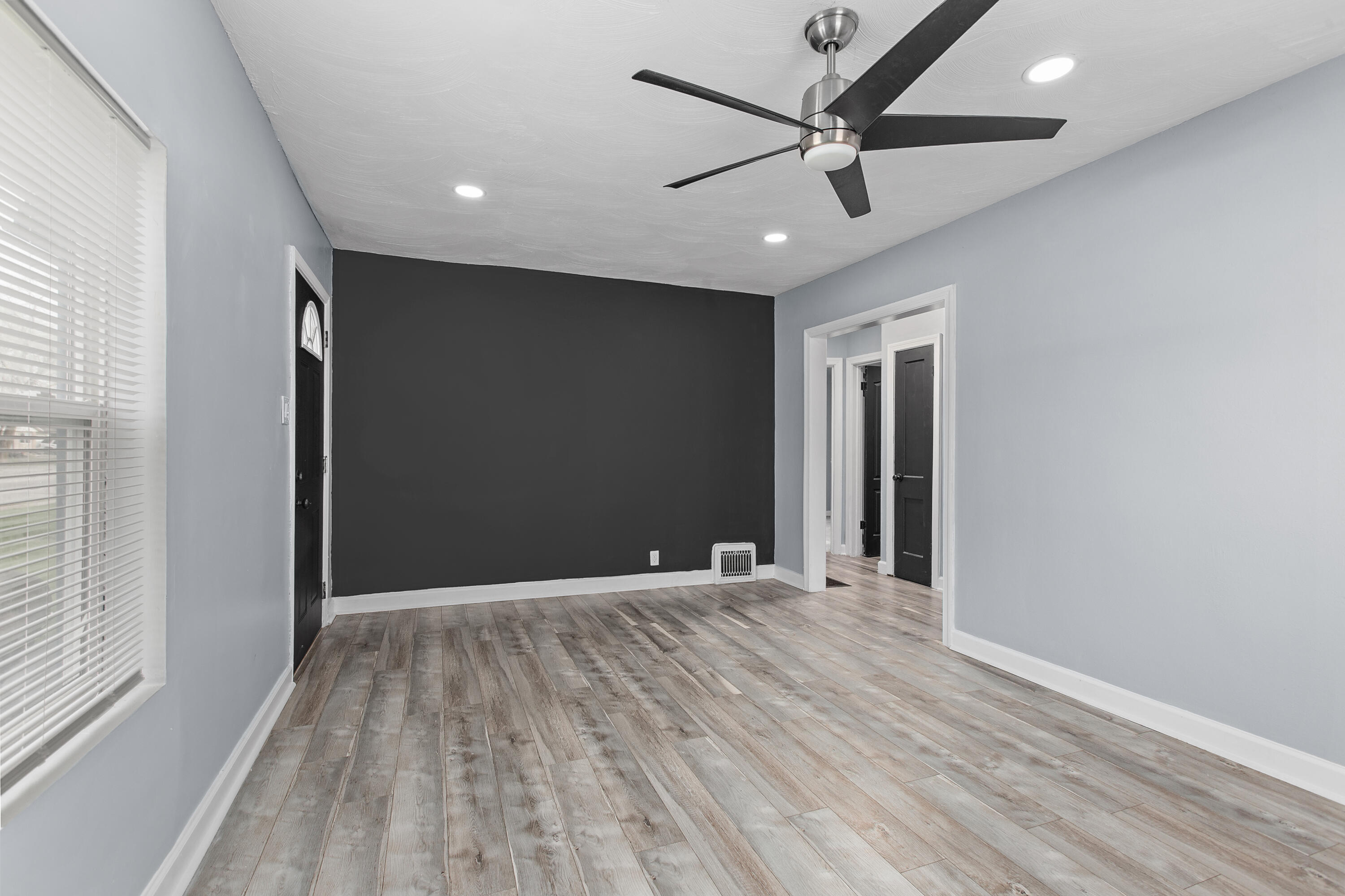 621 Burr Street Gary, IN 46406 - Photo 4 of 13 wooden floor in an empty room with a window