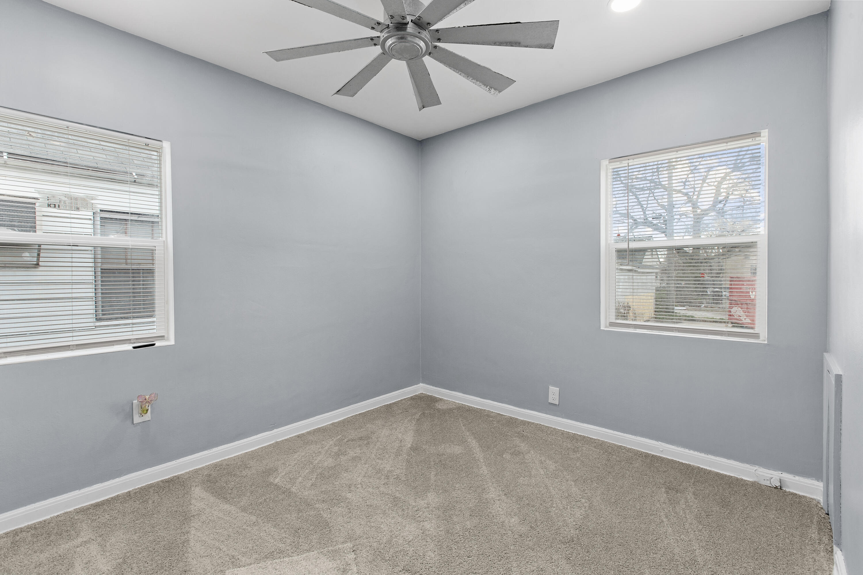 621 Burr Street Gary, IN 46406 - Photo 9 of 13 an empty room with a window and a fan