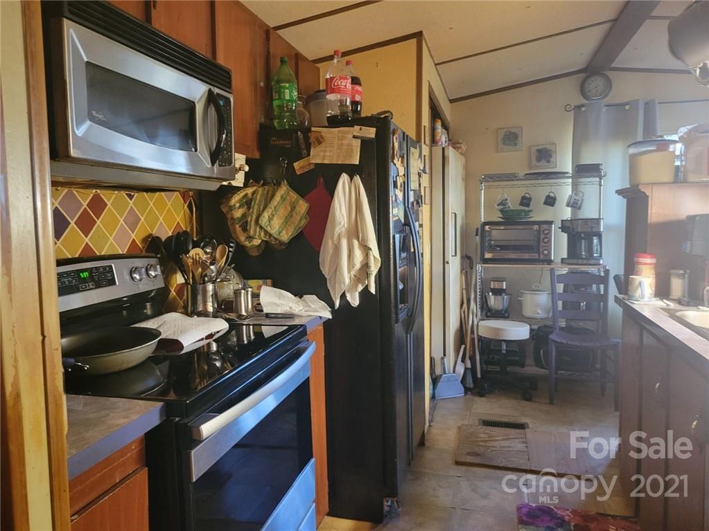 7133 Lingerfelt Road Vale, NC 28168 - Photo 5 of 23 a kitchen view of a stove and a refrigerator