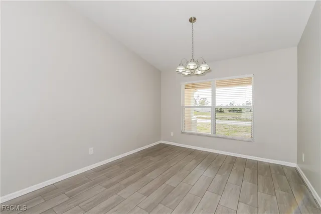 a view of a room with wooden floor and windows