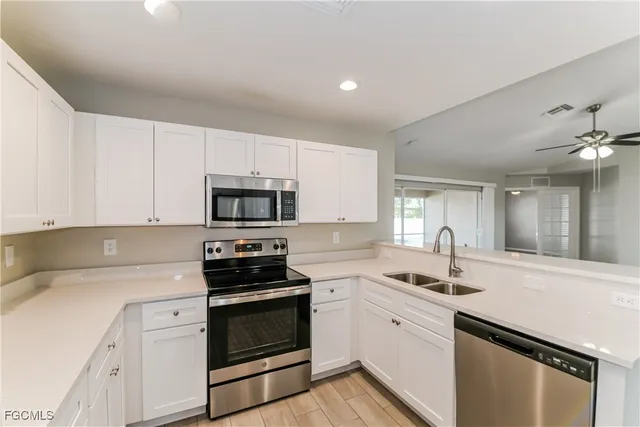 a kitchen with stainless steel appliances granite countertop a sink stove oven a sink with cabinets and wooden floor