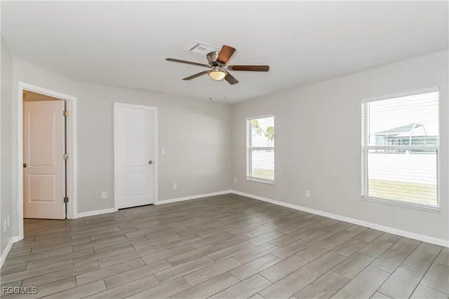wooden floor in an empty room with a window