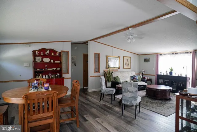 a living room with furniture a rug and a table