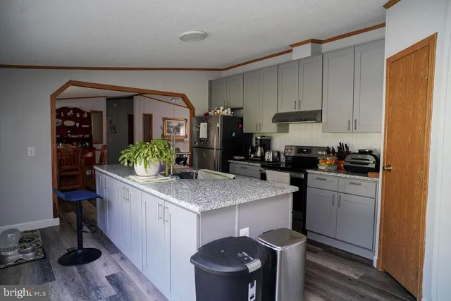 a kitchen with stainless steel appliances granite countertop a sink and cabinets