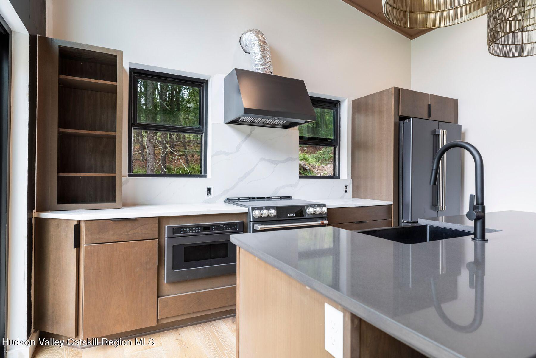 134 Irish Cape Road Napanoch, NY 12458 - Photo 11 of 47 a kitchen with stainless steel appliances granite countertop a stove a refrigerator and a sink