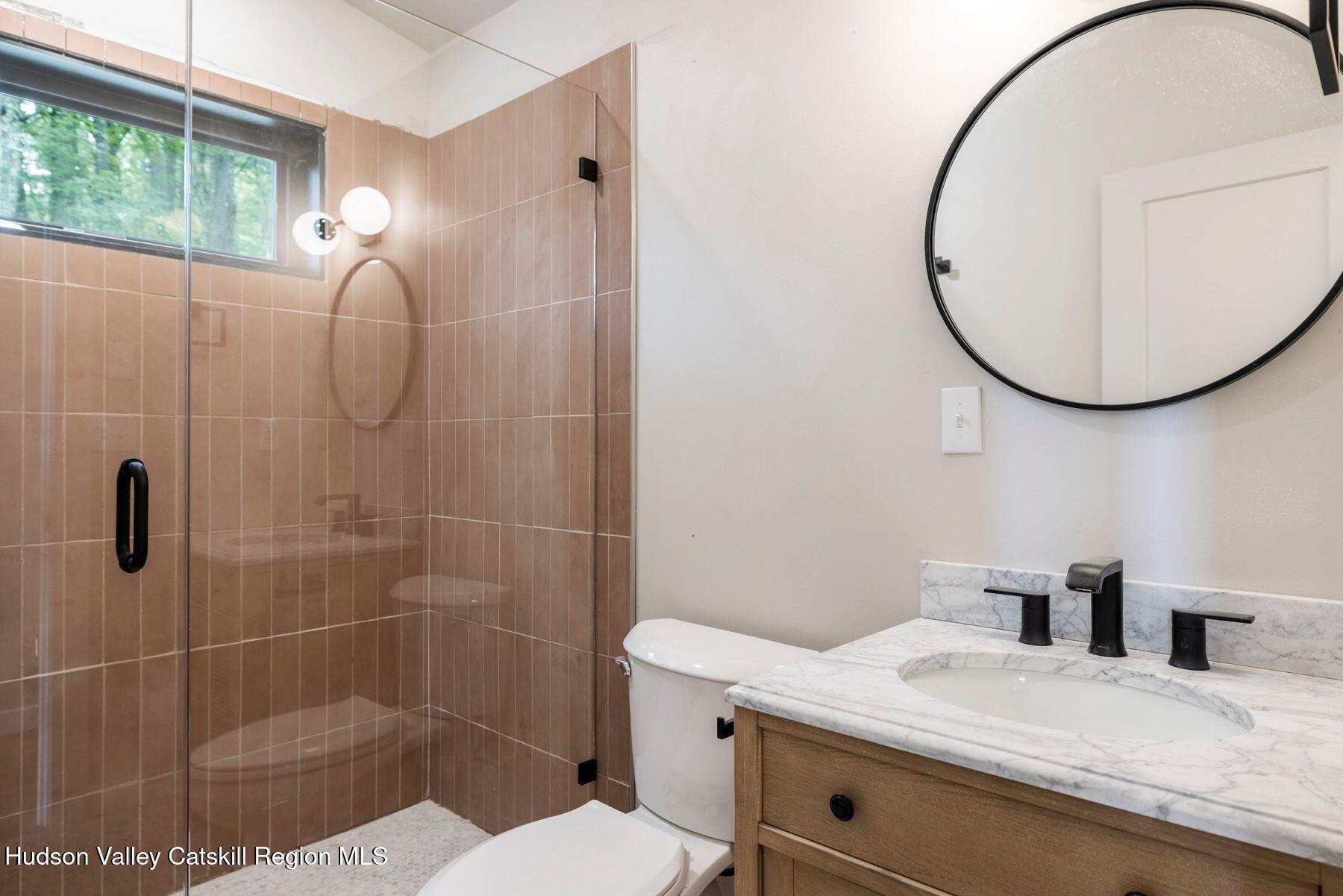 134 Irish Cape Road Napanoch, NY 12458 - Photo 13 of 47 a bathroom with a sink a toilet and a mirror
