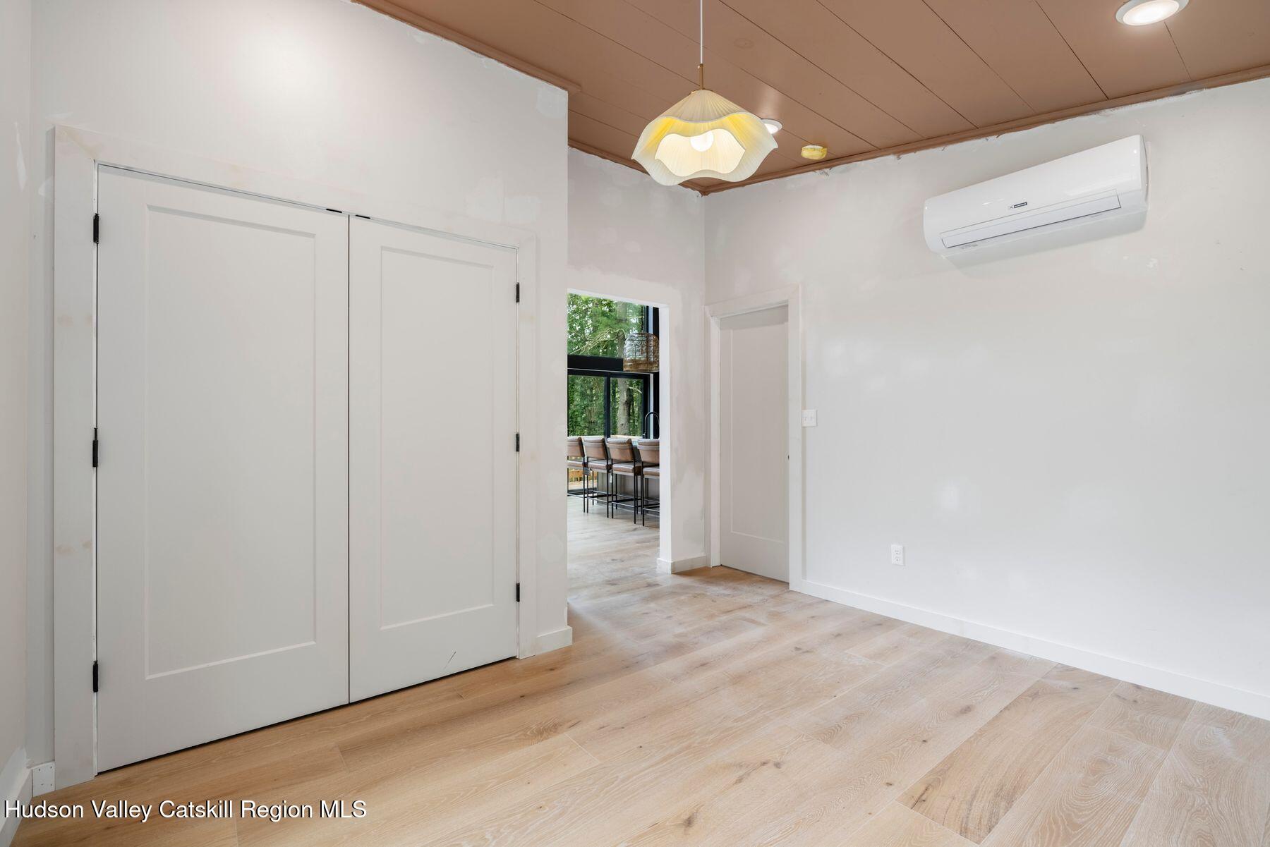 134 Irish Cape Road Napanoch, NY 12458 - Photo 14 of 47 an empty room with closet and chandelier fan