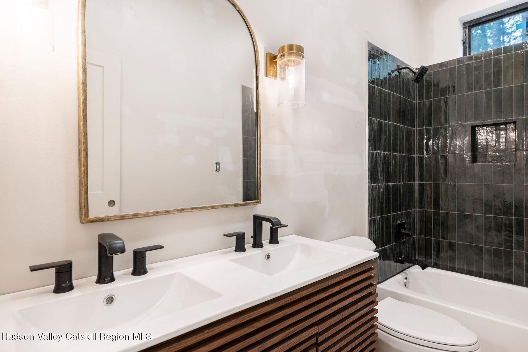 134 Irish Cape Road Napanoch, NY 12458 - Photo 21 of 47 a bathroom with a sink toilet vanity and shower