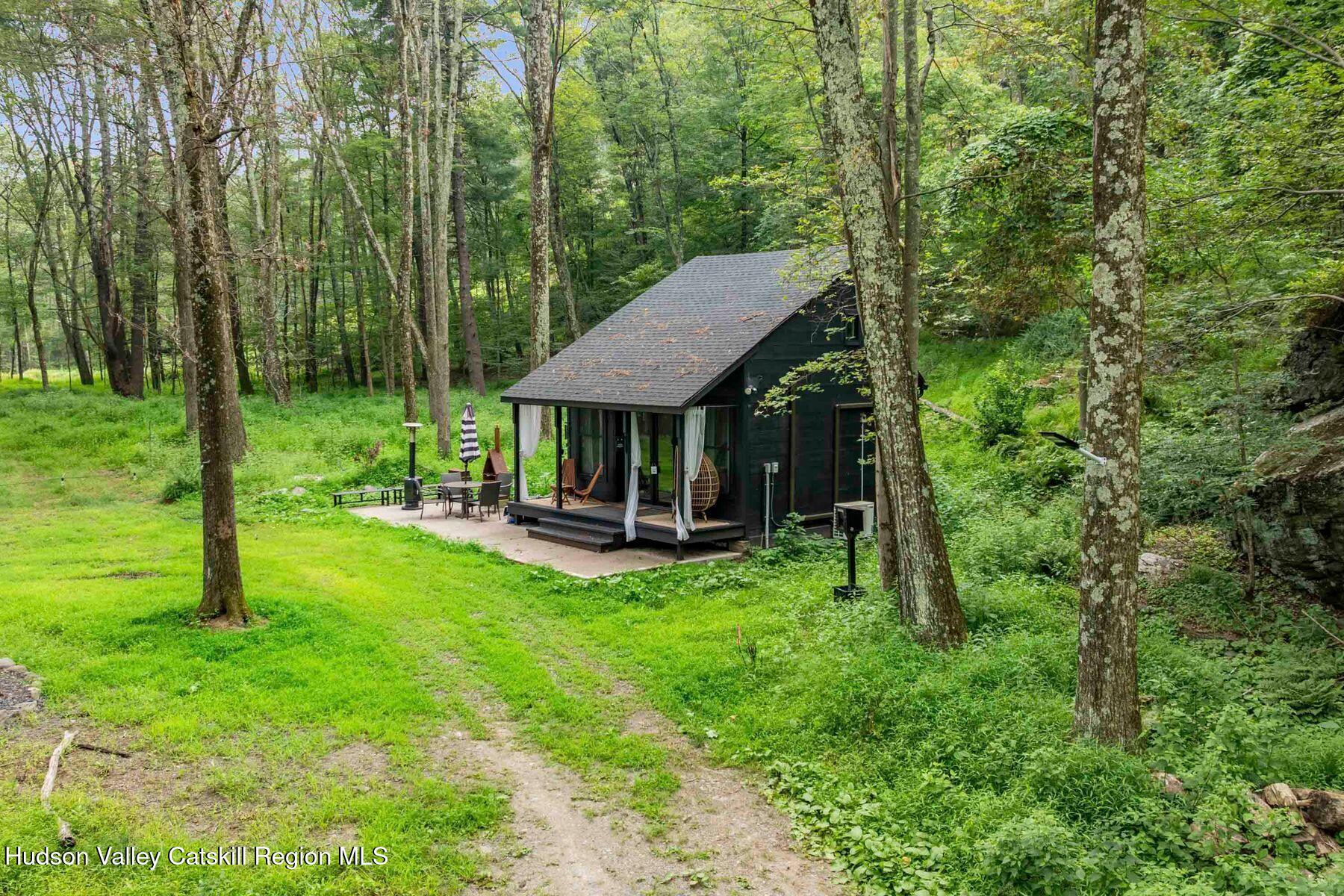 134 Irish Cape Road Napanoch, NY 12458 - Photo 25 of 47 a view of a house with backyard sitting area and garden