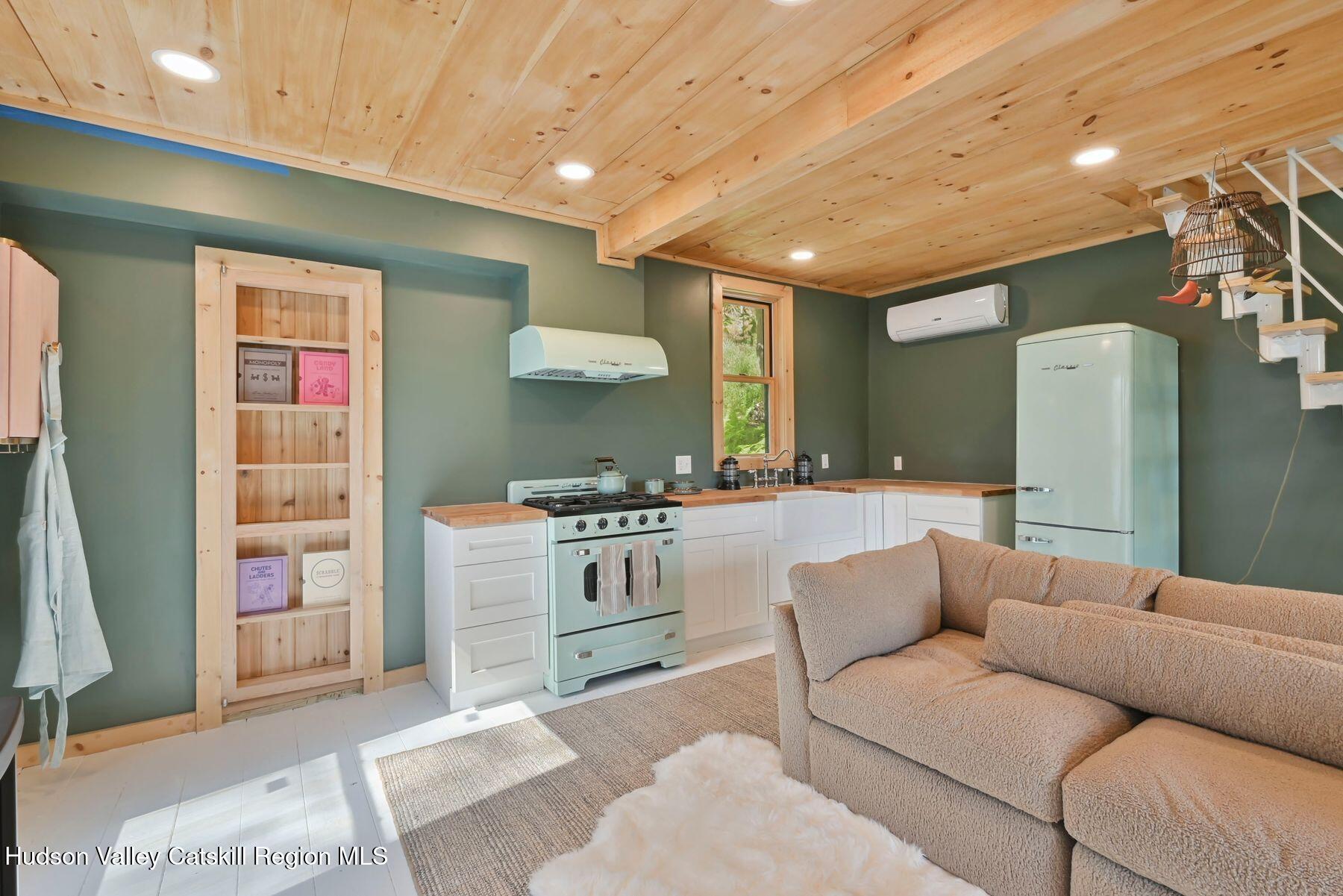 134 Irish Cape Road Napanoch, NY 12458 - Photo 32 of 47 a living room with furniture and a kitchen