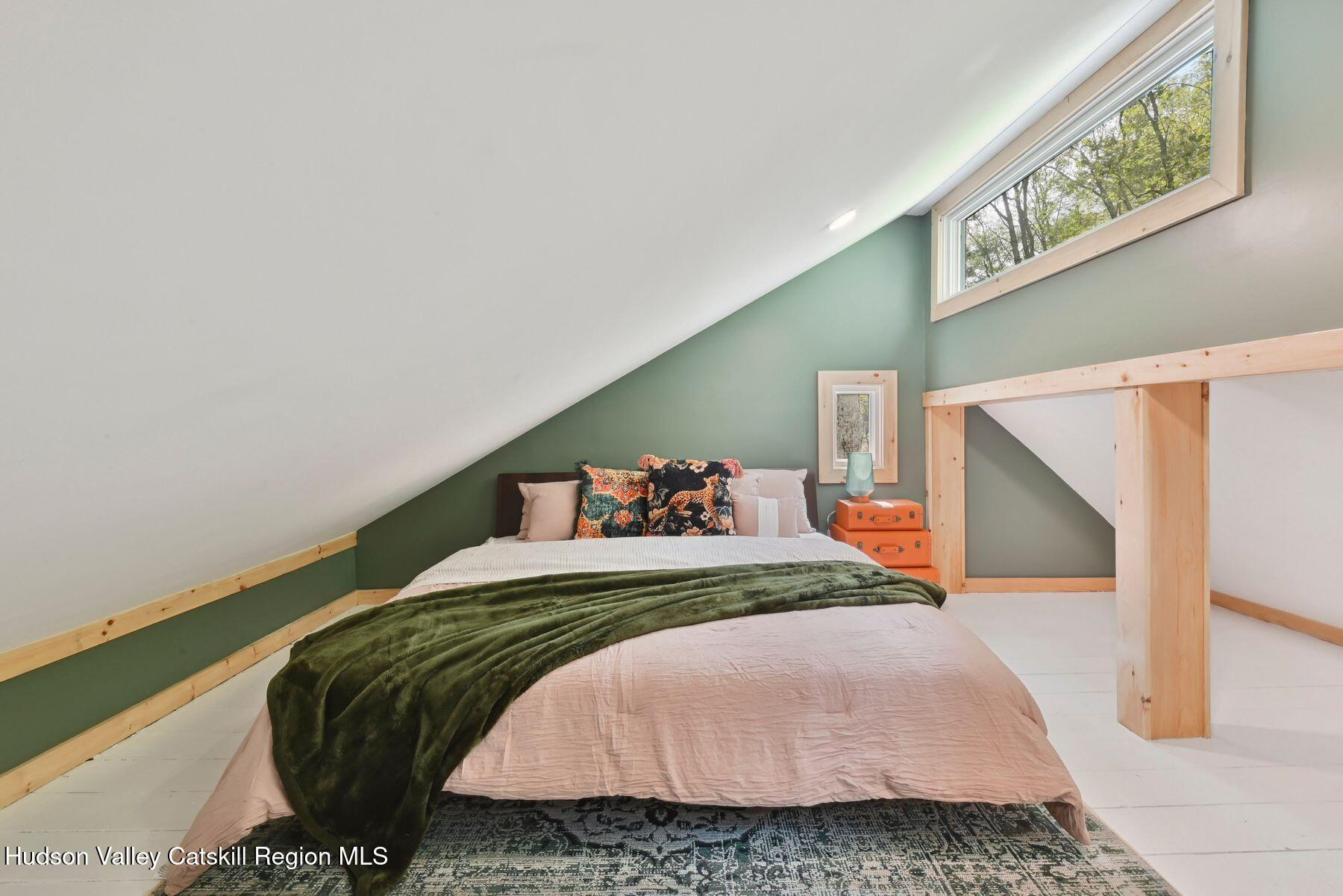 134 Irish Cape Road Napanoch, NY 12458 - Photo 40 of 47 a bedroom with a bed and a painting on the wall