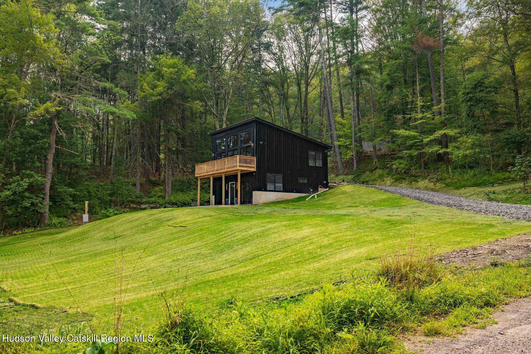 134 Irish Cape Road Napanoch, NY 12458 - Photo 45 of 47 a view of a big yard with large trees and a small yard