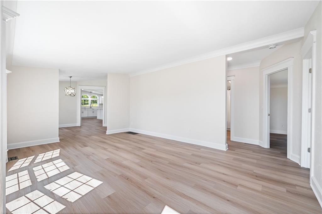 2118 Spooky Hollow Road Lower Burrell, PA 15068 - Photo 16 of 44 an empty room with wooden floor & windows